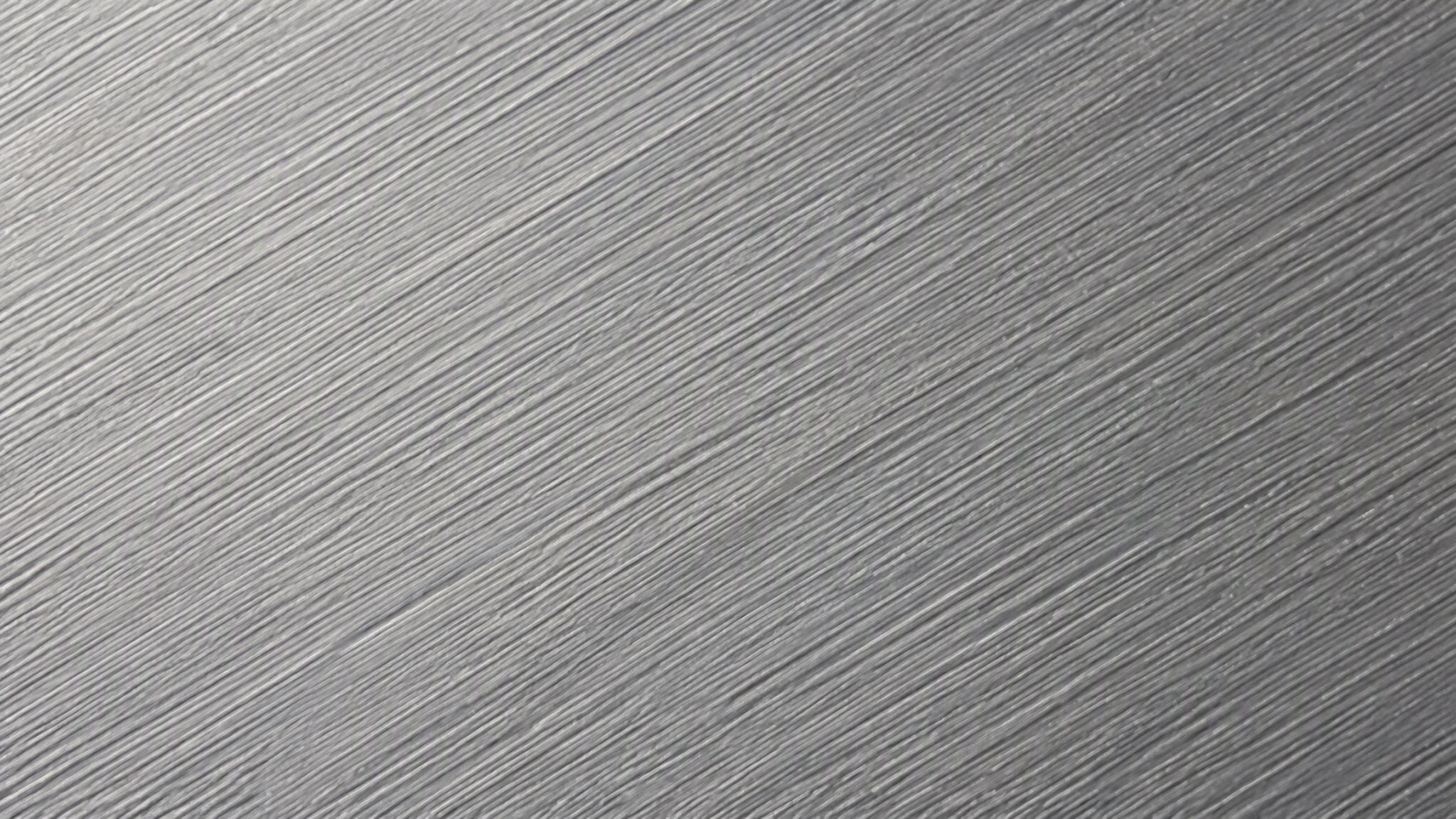 Macro view of the linear hairline grain on a brushed anodized aluminium profile surface