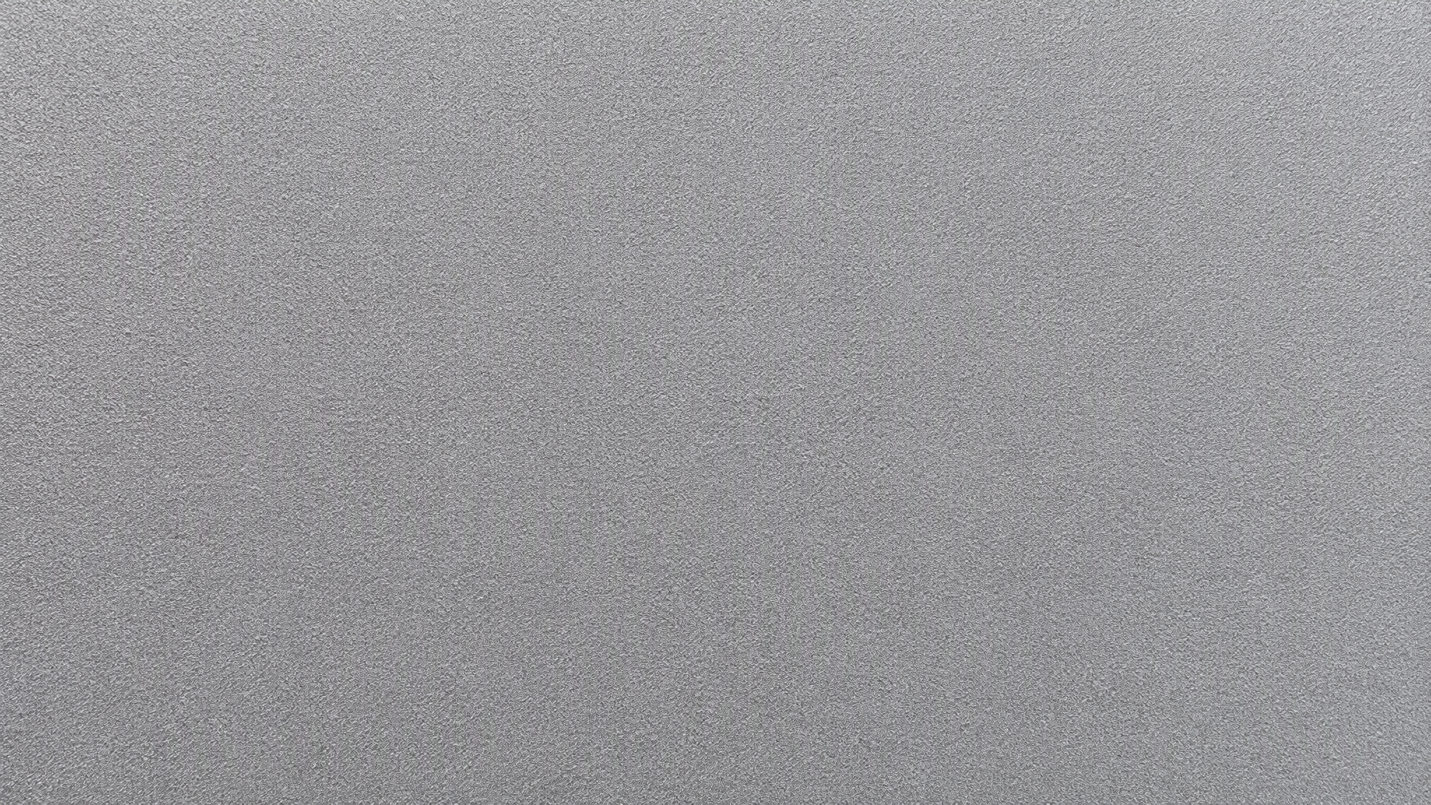 Macro view of the even matte granular texture of a sandblasted anodized aluminium profile